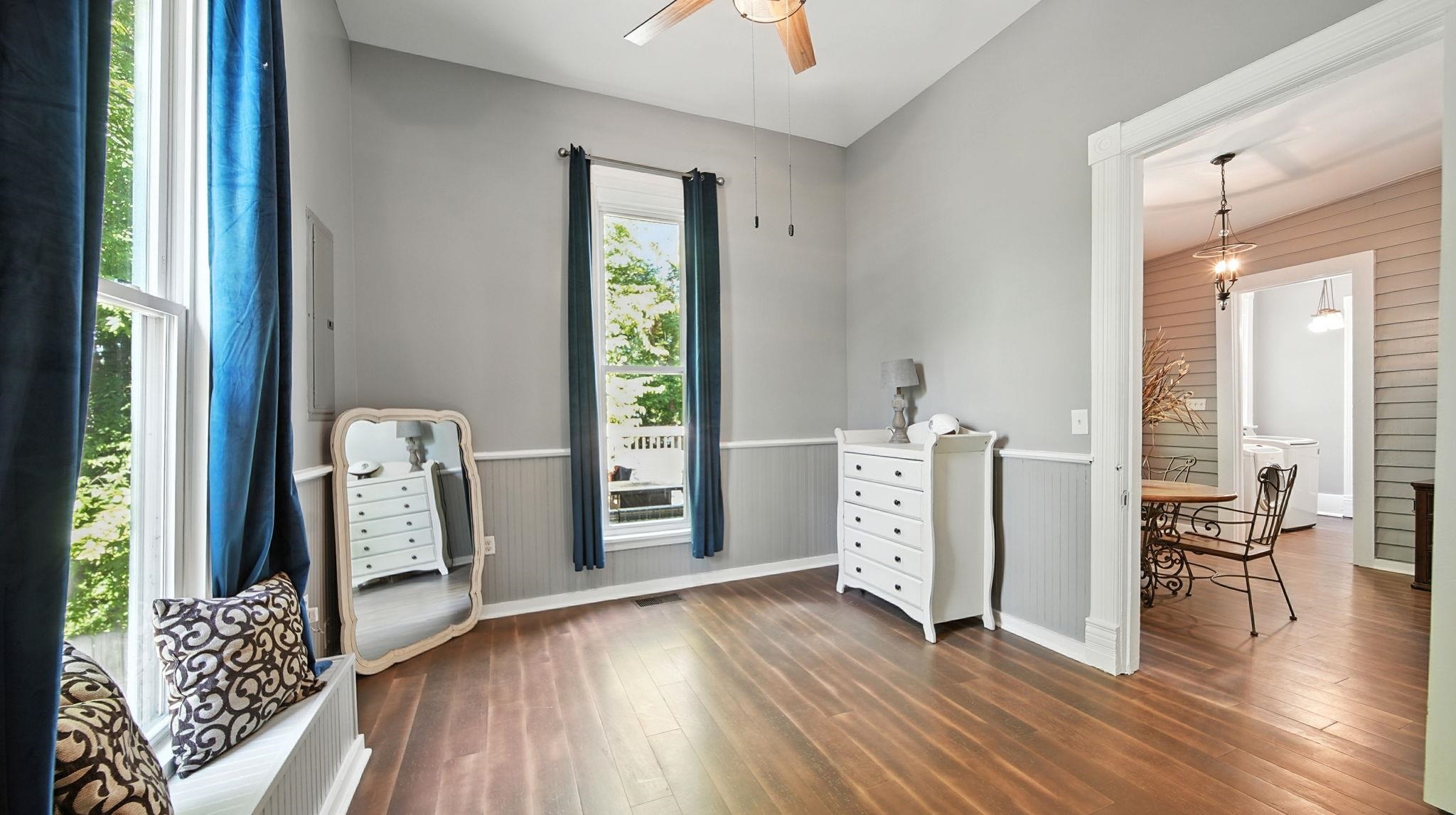 320 North Maple Street Covington, TN 38019 - Photo 26 of 35 Sitting room featuring wood finished floors, wooden walls, ceiling fan, and wainscoting