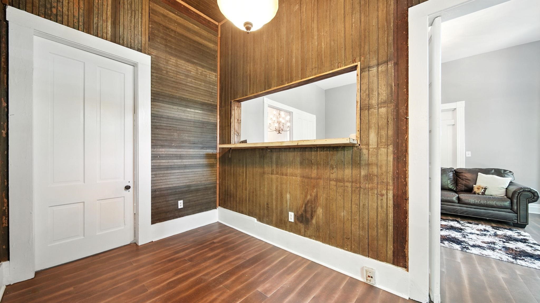 320 North Maple Street Covington, TN 38019 - Photo 27 of 35 Spare room with wooden walls and dark wood finished floors