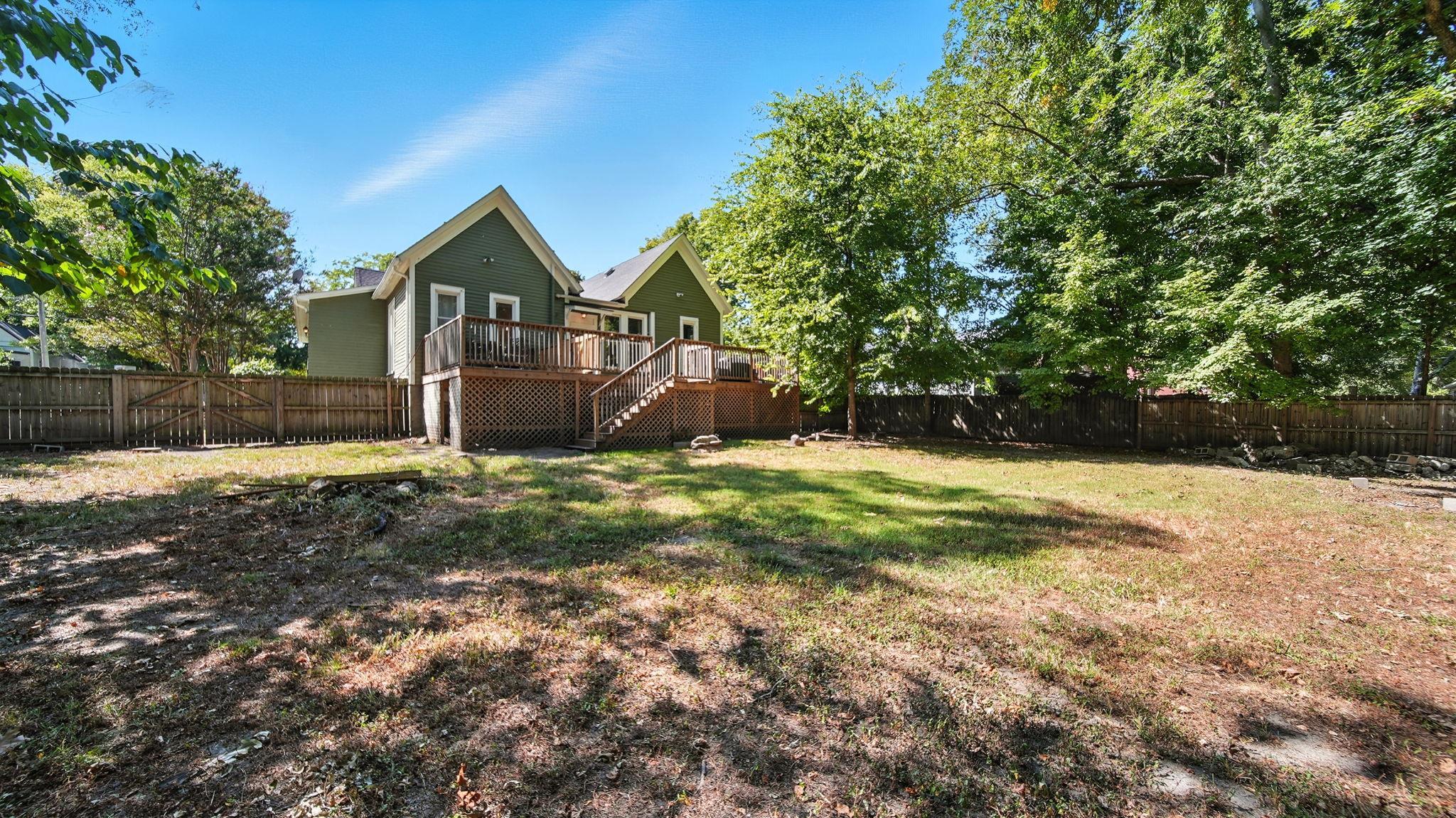 320 North Maple Street Covington, TN 38019 - Photo 35 of 35 Fenced backyard with a deck and stairs