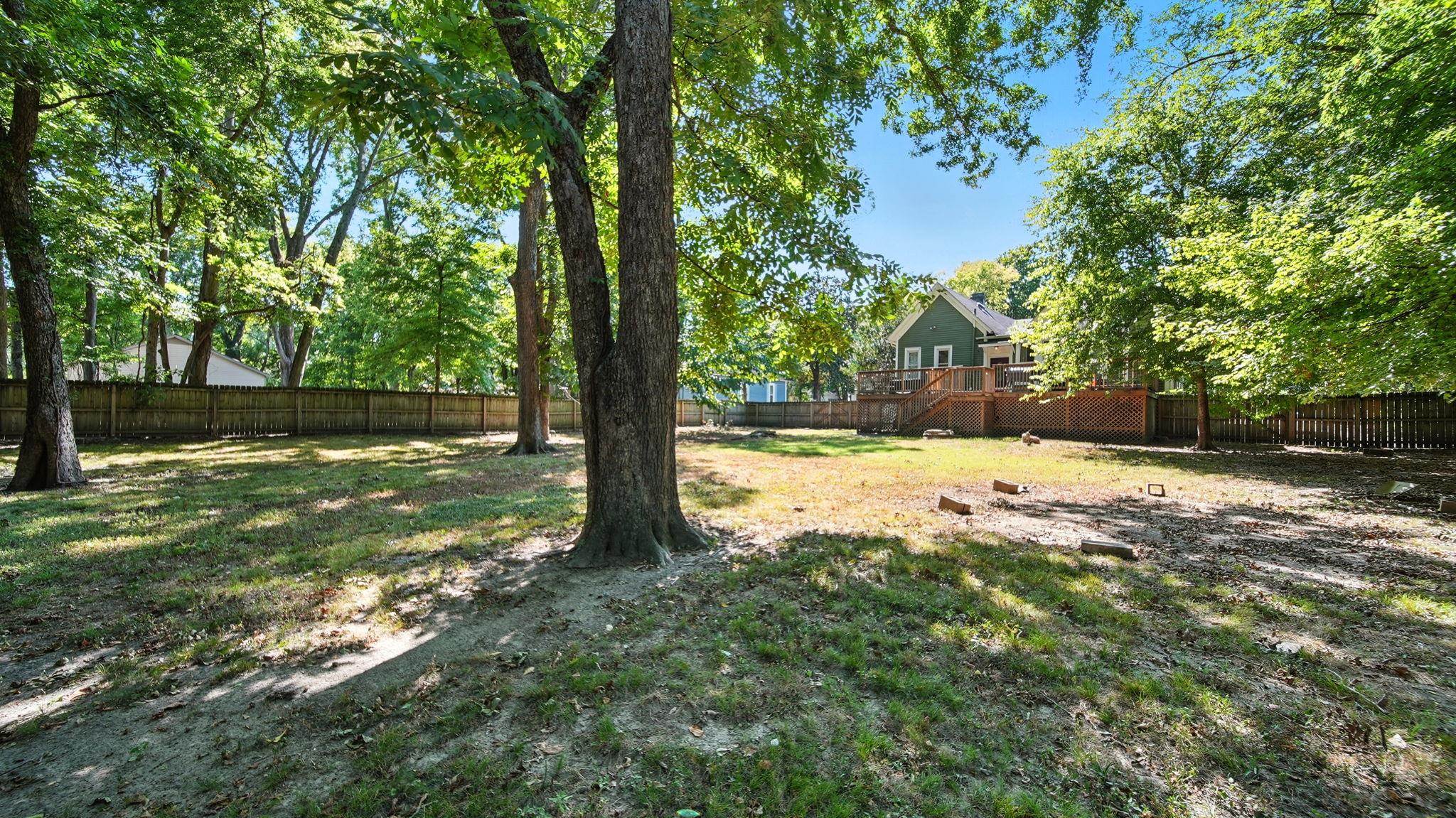 320 North Maple Street Covington, TN 38019 - Photo 5 of 35 Fenced backyard with a deck and stairs