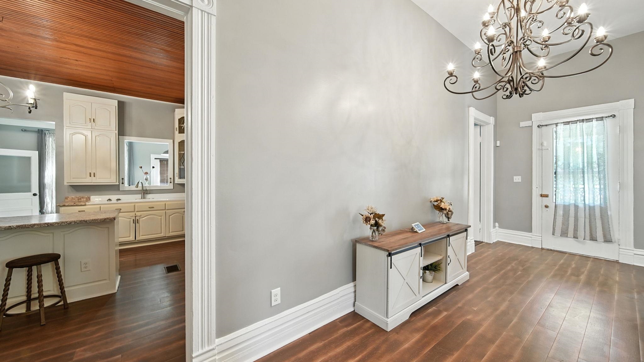 320 North Maple Street Covington, TN 38019 - Photo 8 of 35 Entrance foyer featuring a chandelier and dark wood-style floors
