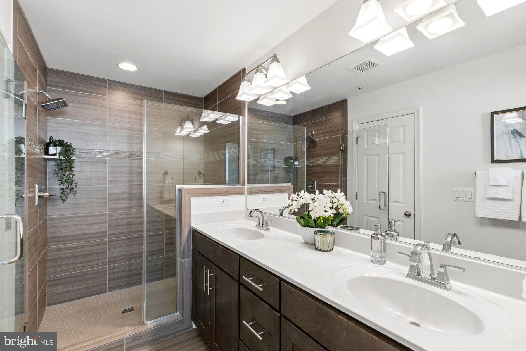 7205 Barry Lane Elkridge, MD 21075 - Photo 15 of 22 a bathroom with a double vanity sink mirror and shower