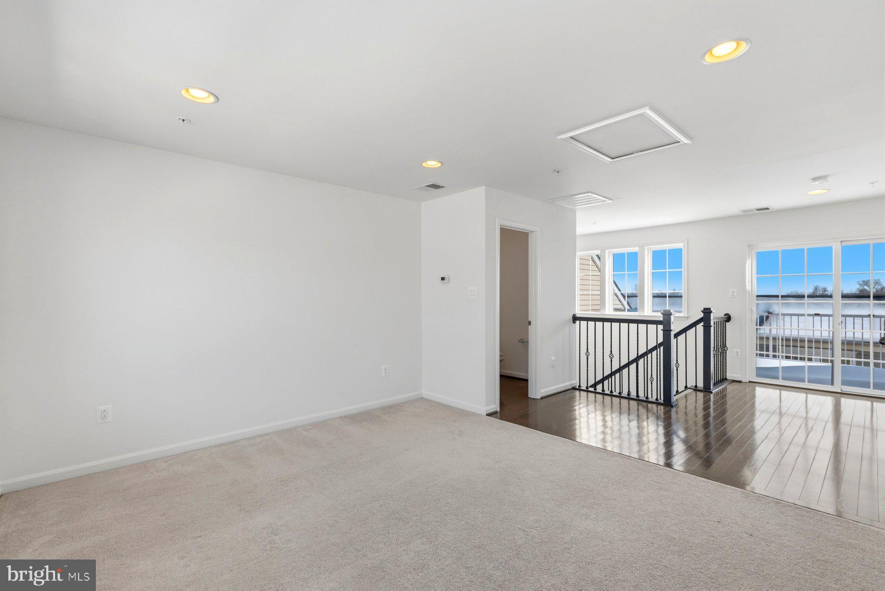 7205 Barry Lane Elkridge, MD 21075 - Photo 19 of 22 a view of a hallway with wooden floor and windows