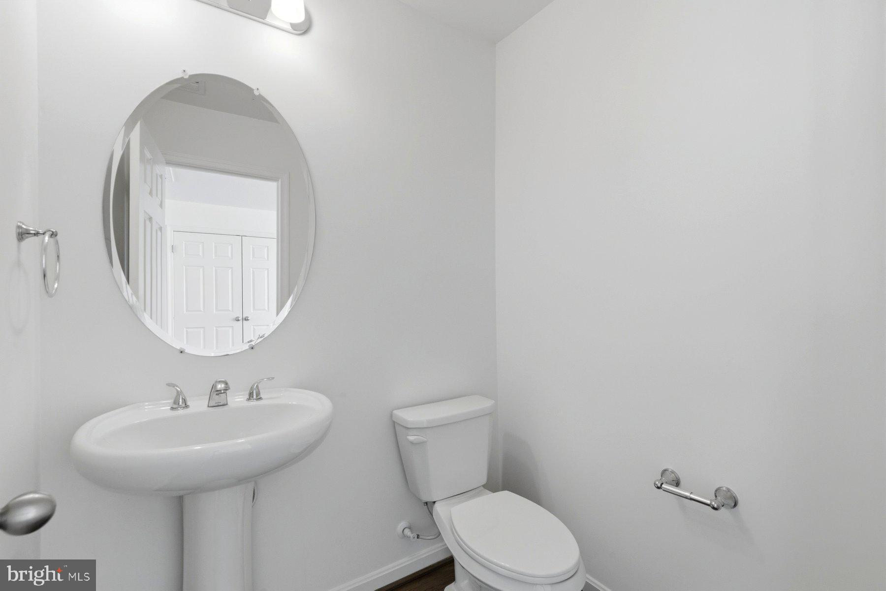 7205 Barry Lane Elkridge, MD 21075 - Photo 20 of 22 a bathroom with a toilet a sink and mirror