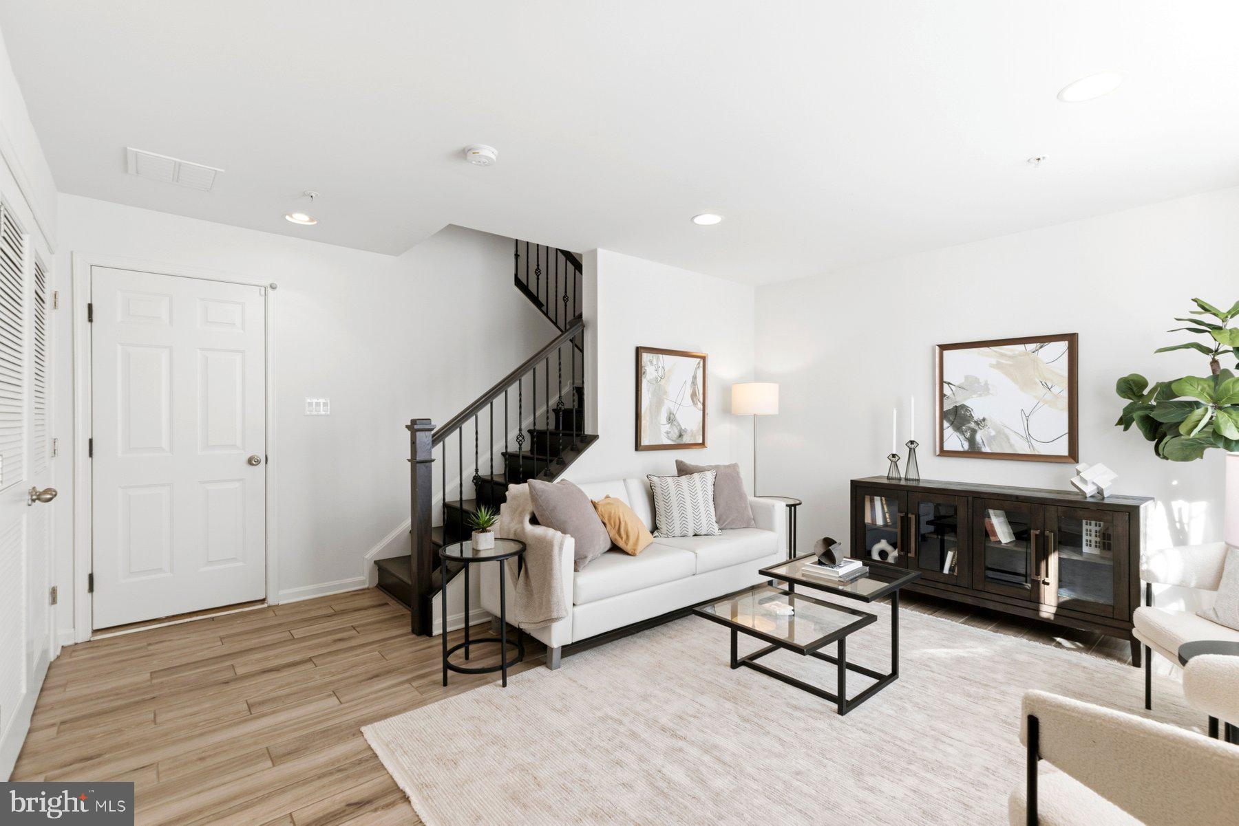 7205 Barry Lane Elkridge, MD 21075 - Photo 2 of 22 a living room with furniture and a fireplace