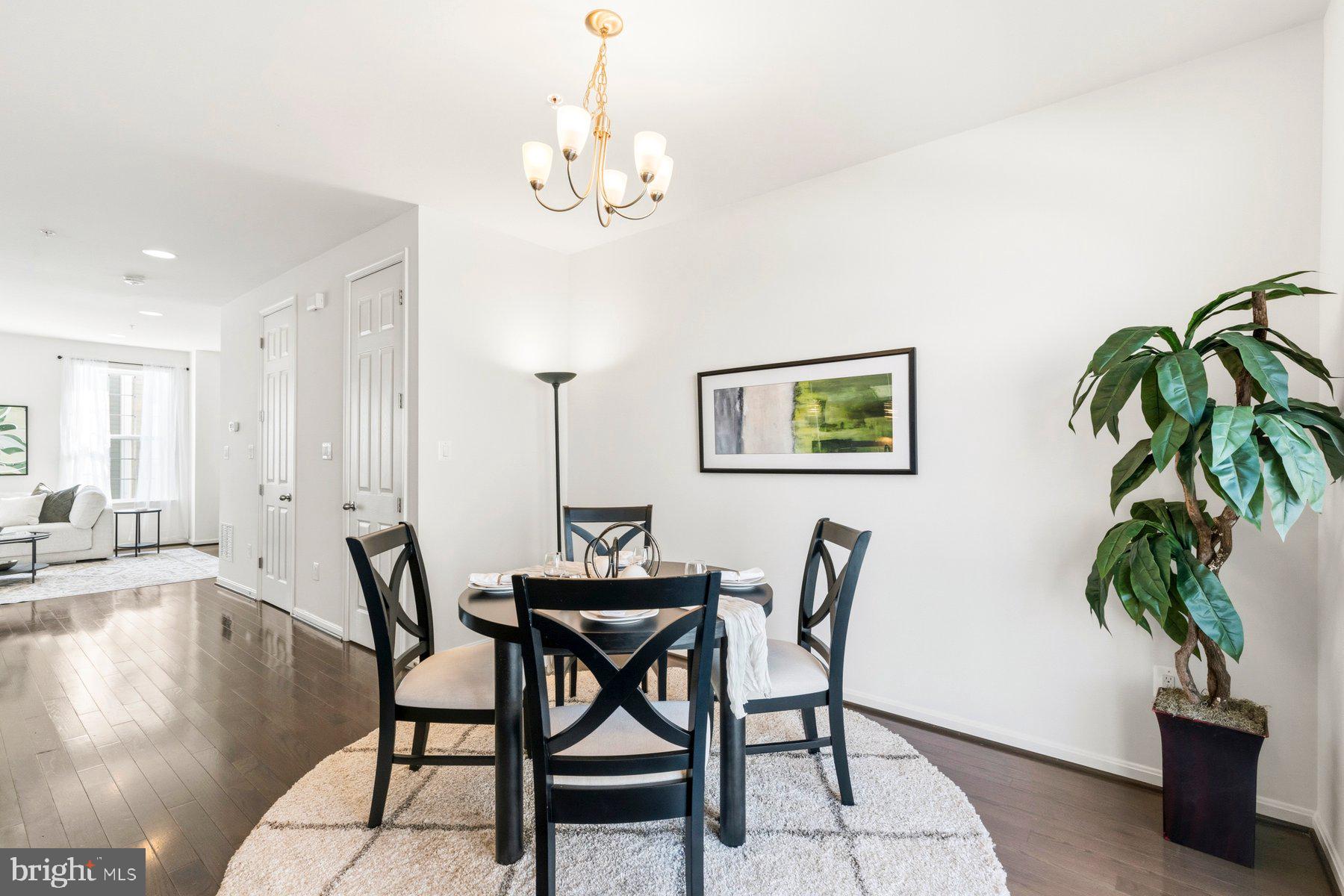 7205 Barry Lane Elkridge, MD 21075 - Photo 5 of 22 a view of a dining room with furniture wooden floor and a chandelier