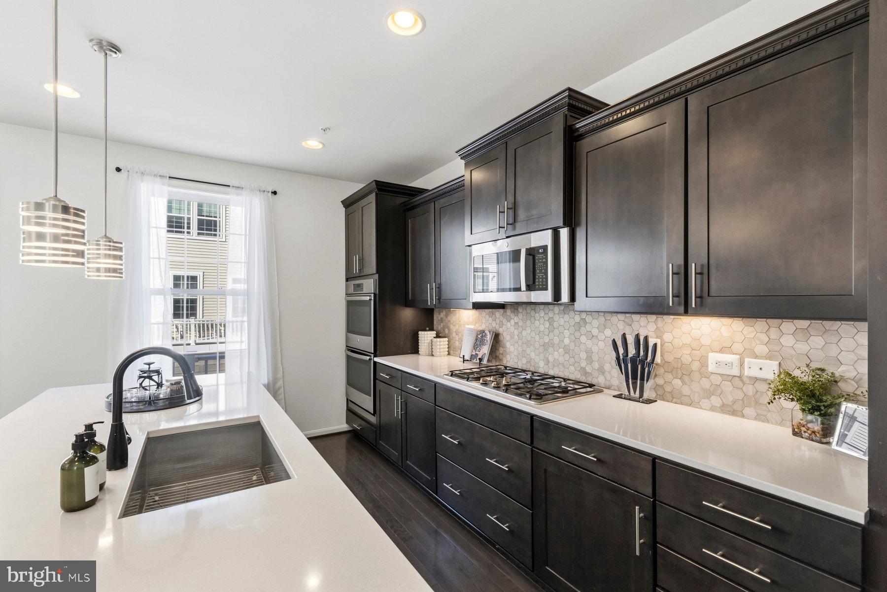 7205 Barry Lane Elkridge, MD 21075 - Photo 6 of 22 a kitchen with a refrigerator and a sink