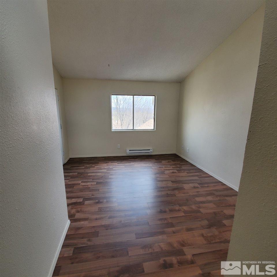 2085 Highview Court, Unit 4 Reno, NV 89512 - Photo 5 of 8 an empty room with wooden floor and windows