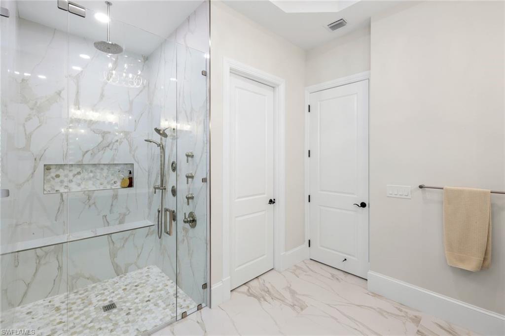 2106 Modena Court Naples, FL 34105 - Photo 24 of 42 a bathroom with a shower and a sink