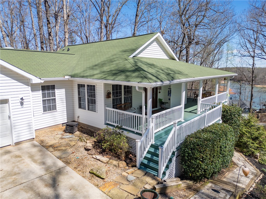 This charming lakeside home offers a picturesque retreat with expansive outdoor living spaces.