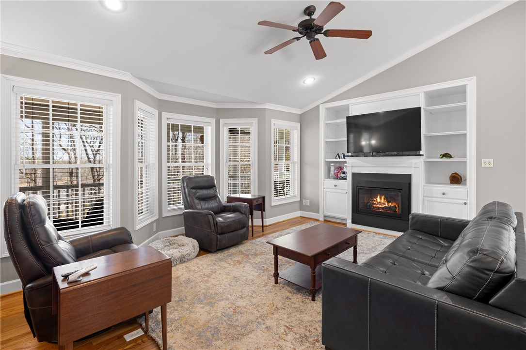 204 Riverlake Road Fair Play, SC 29643 - Photo 11 of 50 This bright living area features a cozy fireplace and expansive windows.