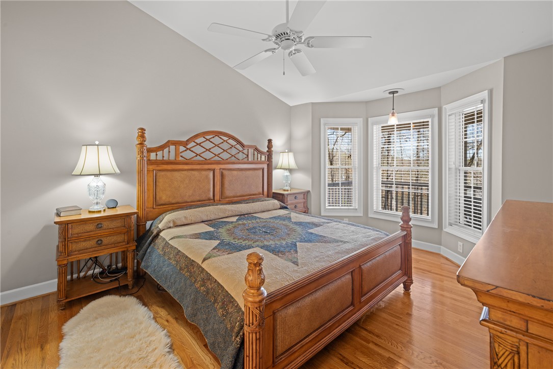 204 Riverlake Road Fair Play, SC 29643 - Photo 15 of 50 This inviting primary bedroom features lustrous hardwood floors and a picturesque bay window overlooking scenic views.