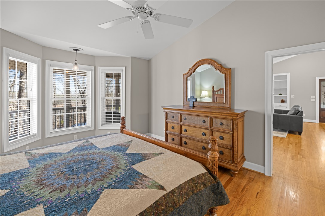 204 Riverlake Road Fair Play, SC 29643 - Photo 16 of 50 This primary bedroom offers warm hardwood floors, an inviting bay window, and vaulted ceilings.