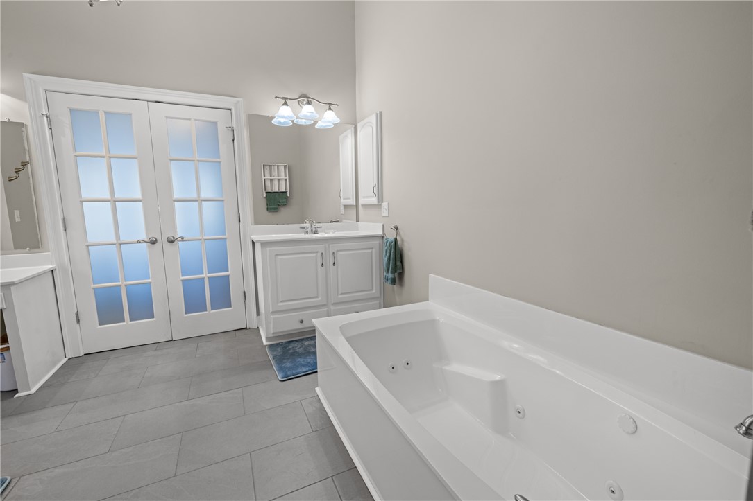 204 Riverlake Road Fair Play, SC 29643 - Photo 19 of 50 This primary bathroom features a luxurious soaking tub, double vanity, and elegant tile flooring.