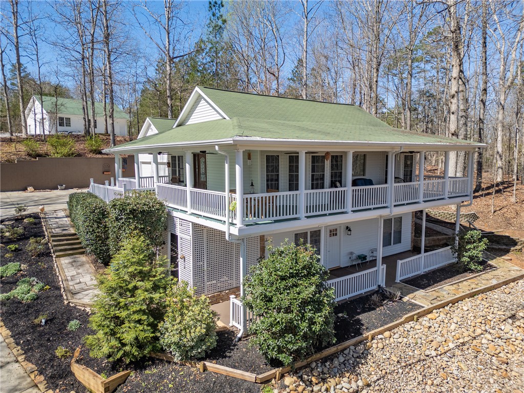 204 Riverlake Road Fair Play, SC 29643 - Photo 2 of 50 This charming home offers expansive outdoor living with dual-level porches and lush surroundings.