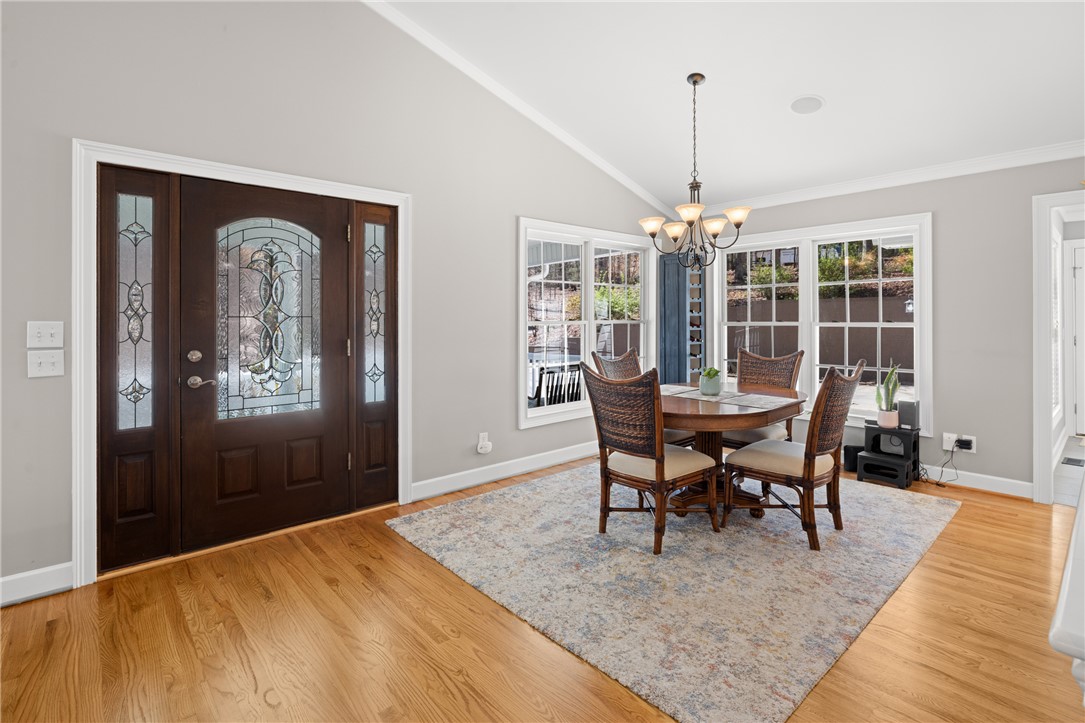204 Riverlake Road Fair Play, SC 29643 - Photo 6 of 50 This inviting dining area features a decorative entryway and large windows, creating a bright and welcoming atmosphere.