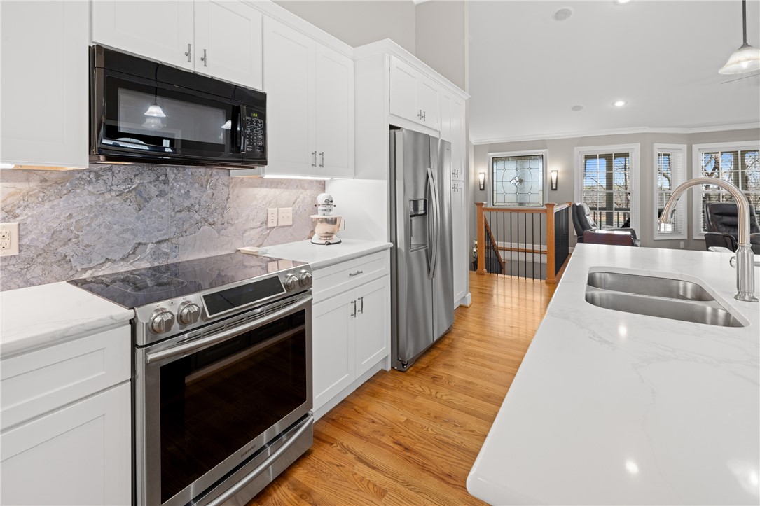 204 Riverlake Road Fair Play, SC 29643 - Photo 8 of 50 This bright kitchen features modern appliances and an inviting open layout with warm wood flooring.
