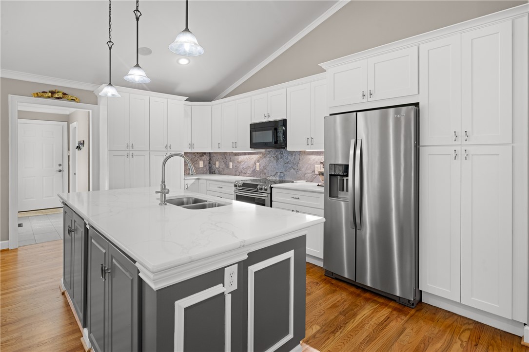 204 Riverlake Road Fair Play, SC 29643 - Photo 9 of 50 This modern kitchen features a large island and contemporary finishes, perfect for culinary endeavors.