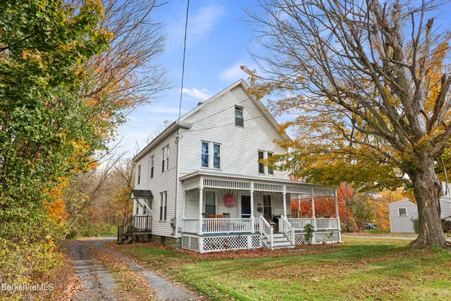 a front view of house with yard space and swimming pool