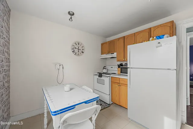 a kitchen with a refrigerator a stove a sink and a refrigerator