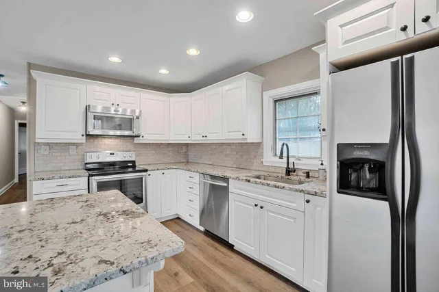 a kitchen with a sink stove and refrigerator