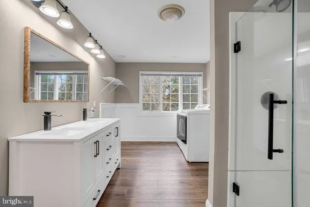 a bathroom with a sink a toilet and shower