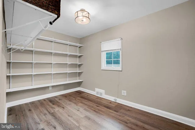 a view of a room with wooden floor and window