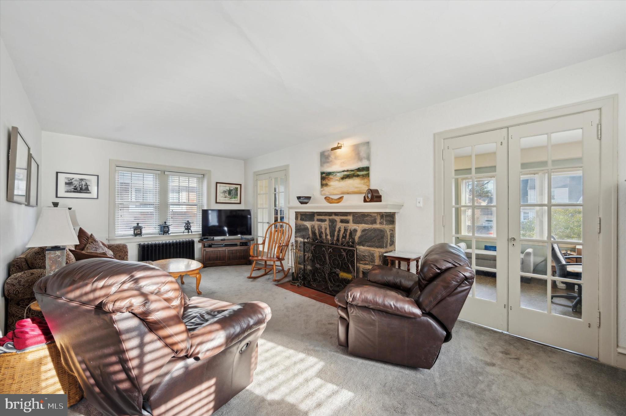 4009 State Road Drexel Hill, PA 19026 - Photo 5 of 26 a living room with furniture a fireplace and a flat screen tv