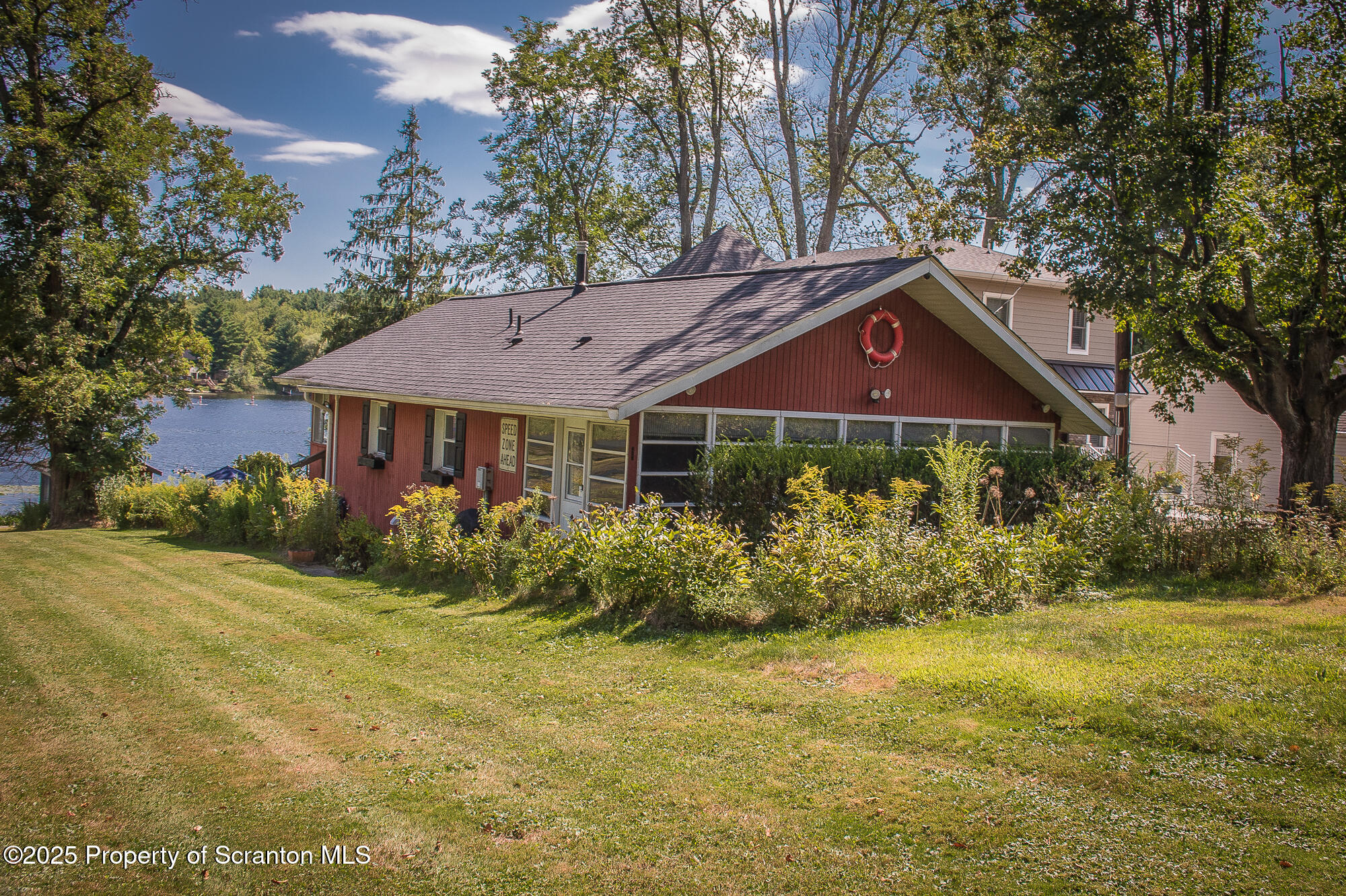 a front view of house with yard and green space