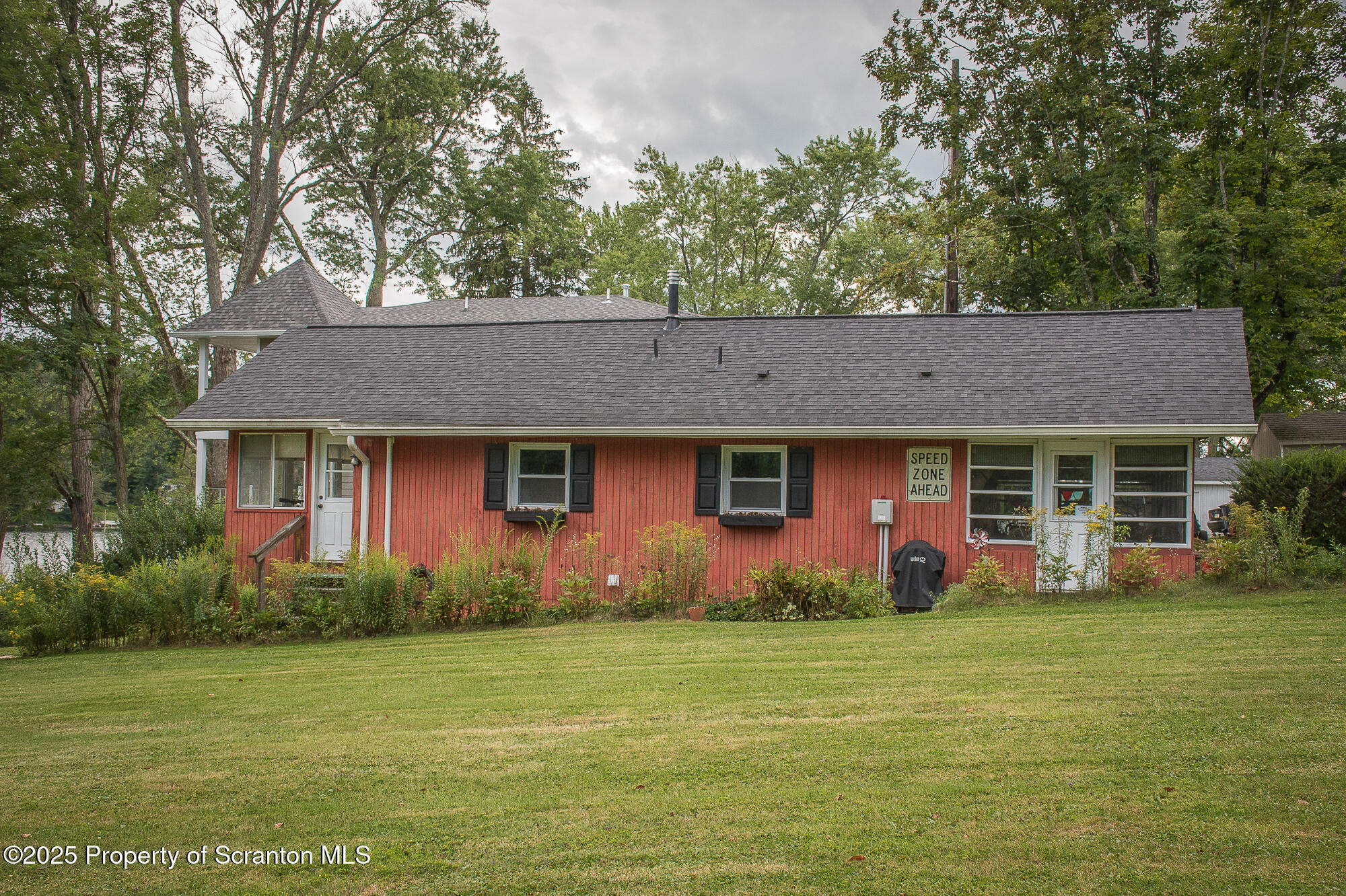 260 Baylors Lake Road Fleetville, PA 18420 - Photo 17 of 69 a front view of house with yard and trees in the background