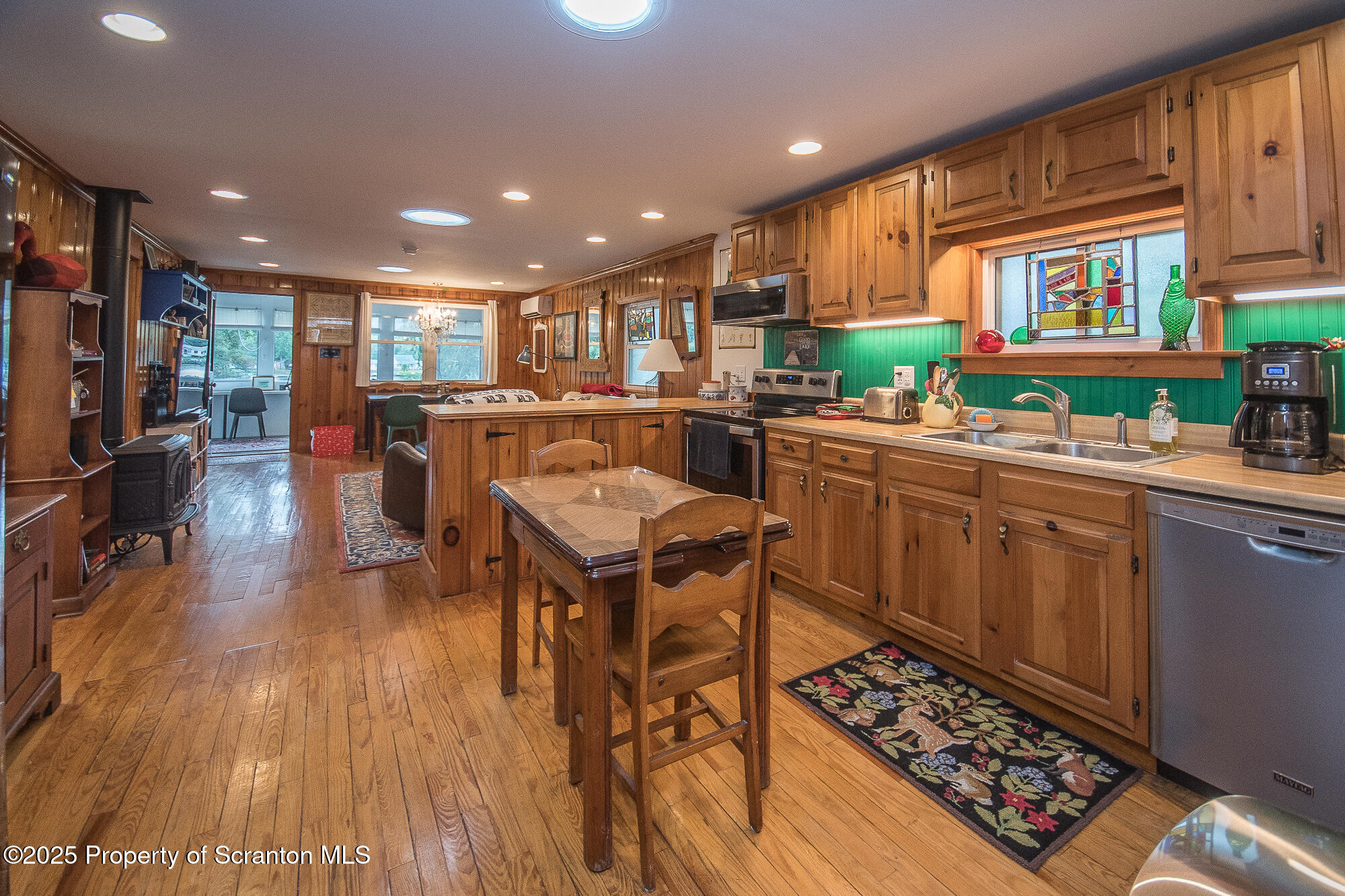 260 Baylors Lake Road Fleetville, PA 18420 - Photo 26 of 69 a kitchen with stainless steel appliances granite countertop a stove top oven a sink dishwasher and cabinets with wooden floor