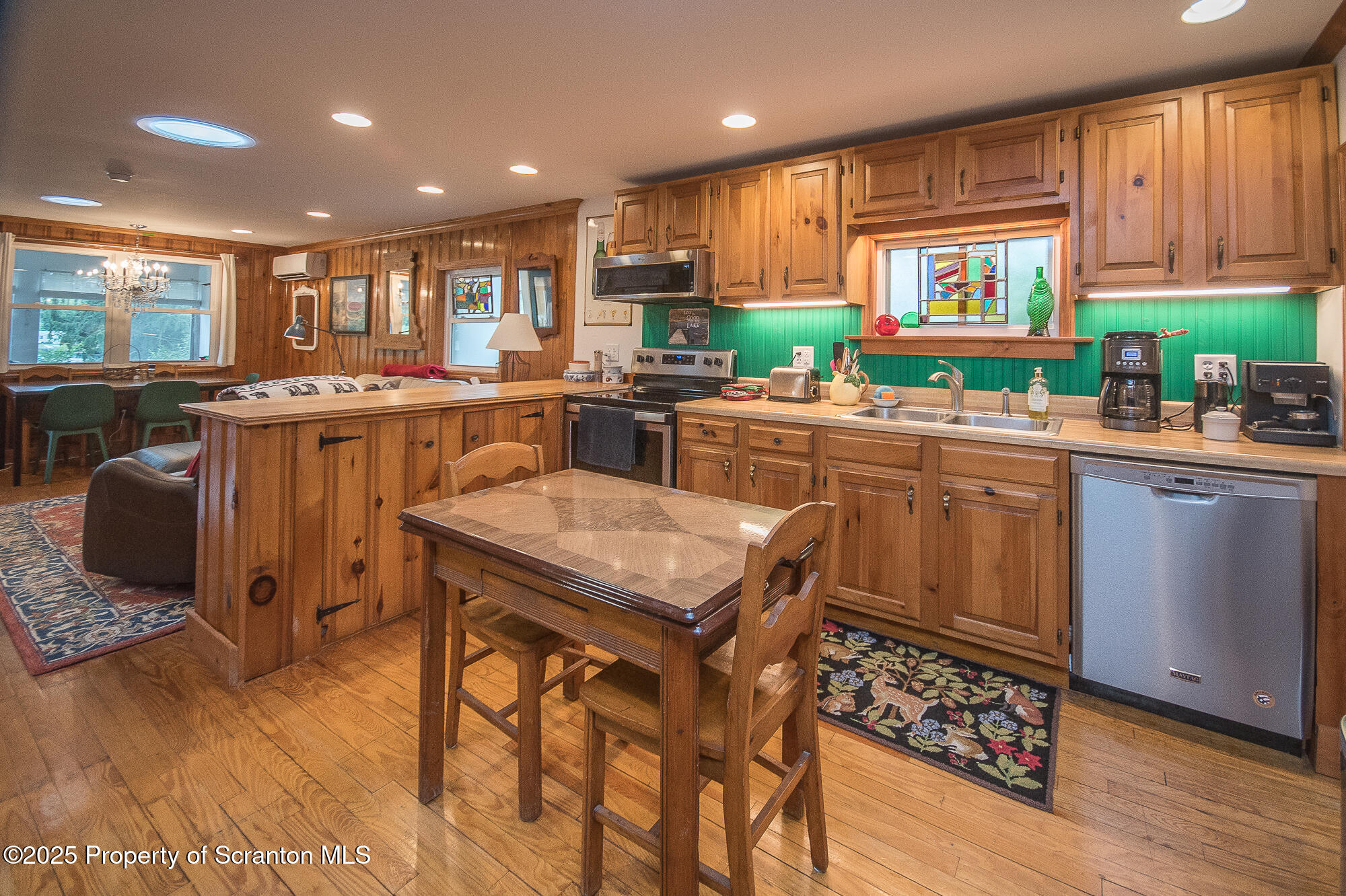 260 Baylors Lake Road Fleetville, PA 18420 - Photo 27 of 69 a kitchen with a table chairs refrigerator and microwave