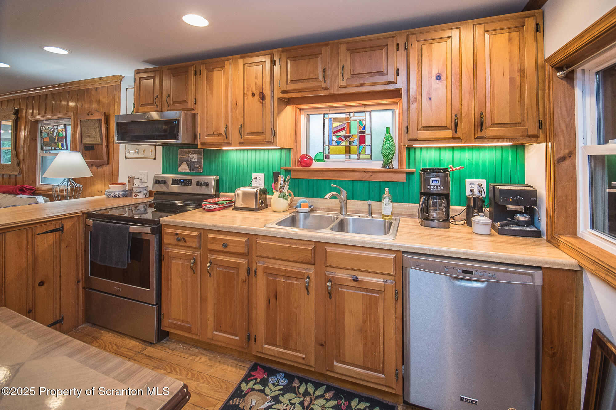 260 Baylors Lake Road Fleetville, PA 18420 - Photo 29 of 69 a kitchen with stainless steel appliances a sink stove and cabinets