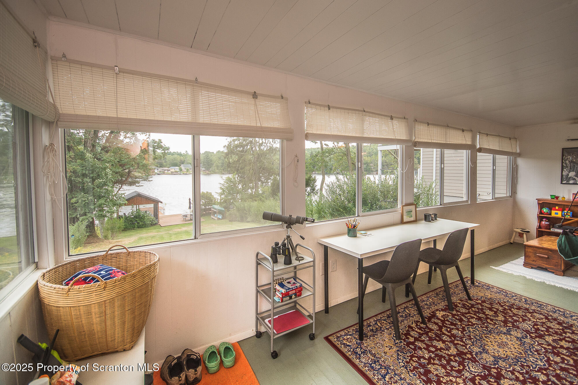 260 Baylors Lake Road Fleetville, PA 18420 - Photo 51 of 69 a table and chairs in a room with a large window