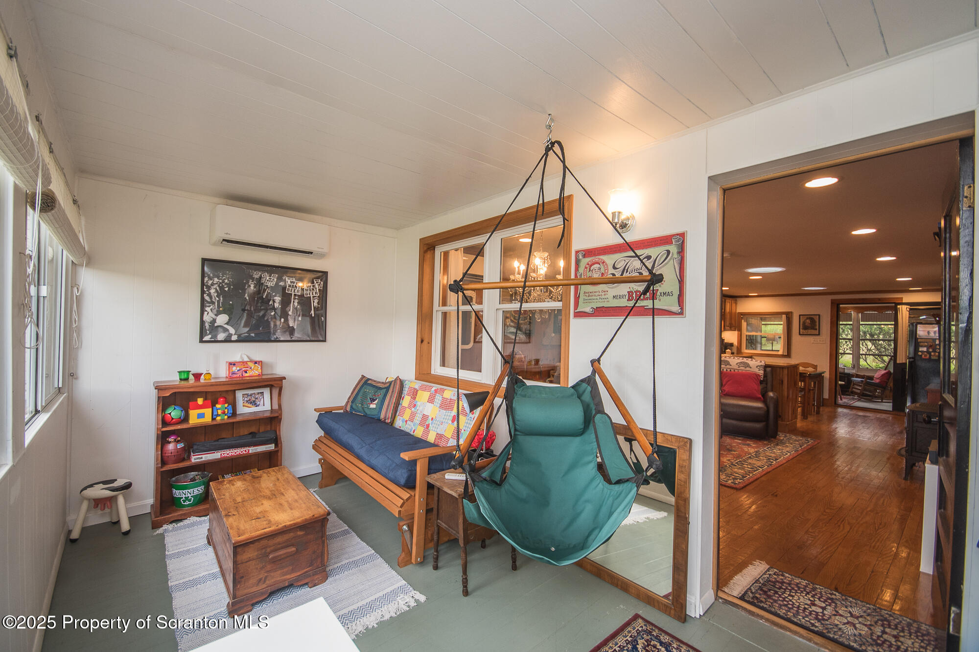260 Baylors Lake Road Fleetville, PA 18420 - Photo 52 of 69 a living room with furniture a rug and a chandelier