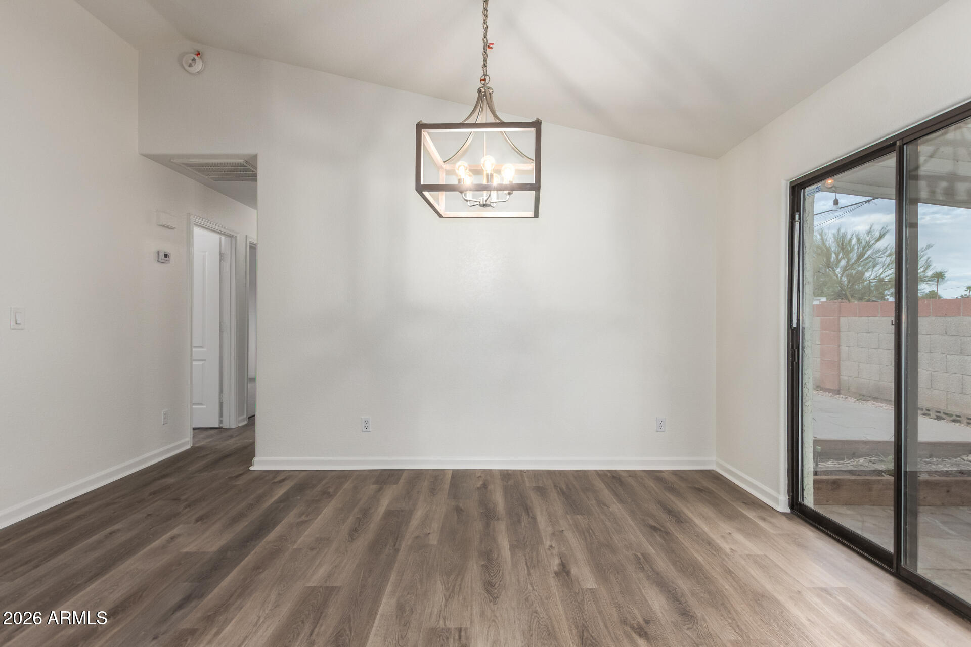 335 South Stardust Lane Apache Junction, AZ 85120 - Photo 11 of 31 an empty room with wooden floor and windows