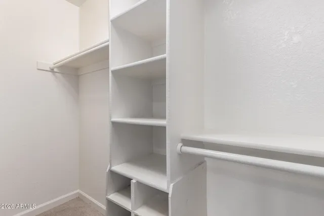 a view of a small space with wooden floor and a window