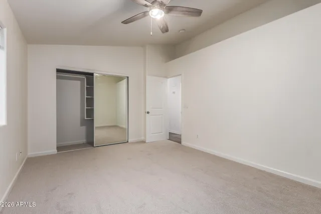 a roof deck with couch and chairs