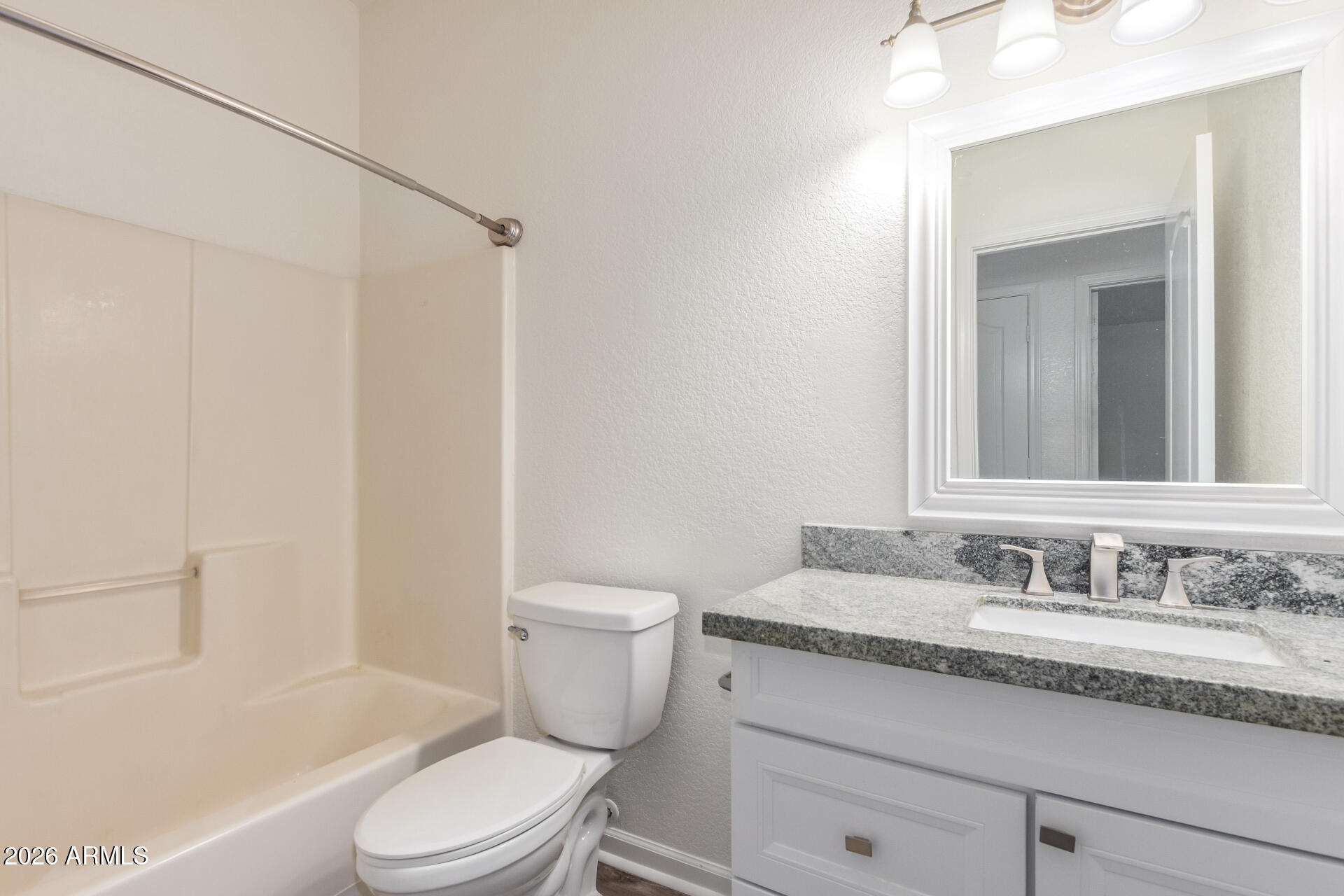 335 South Stardust Lane Apache Junction, AZ 85120 - Photo 18 of 31 a bathroom with a granite countertop sink a toilet and shower