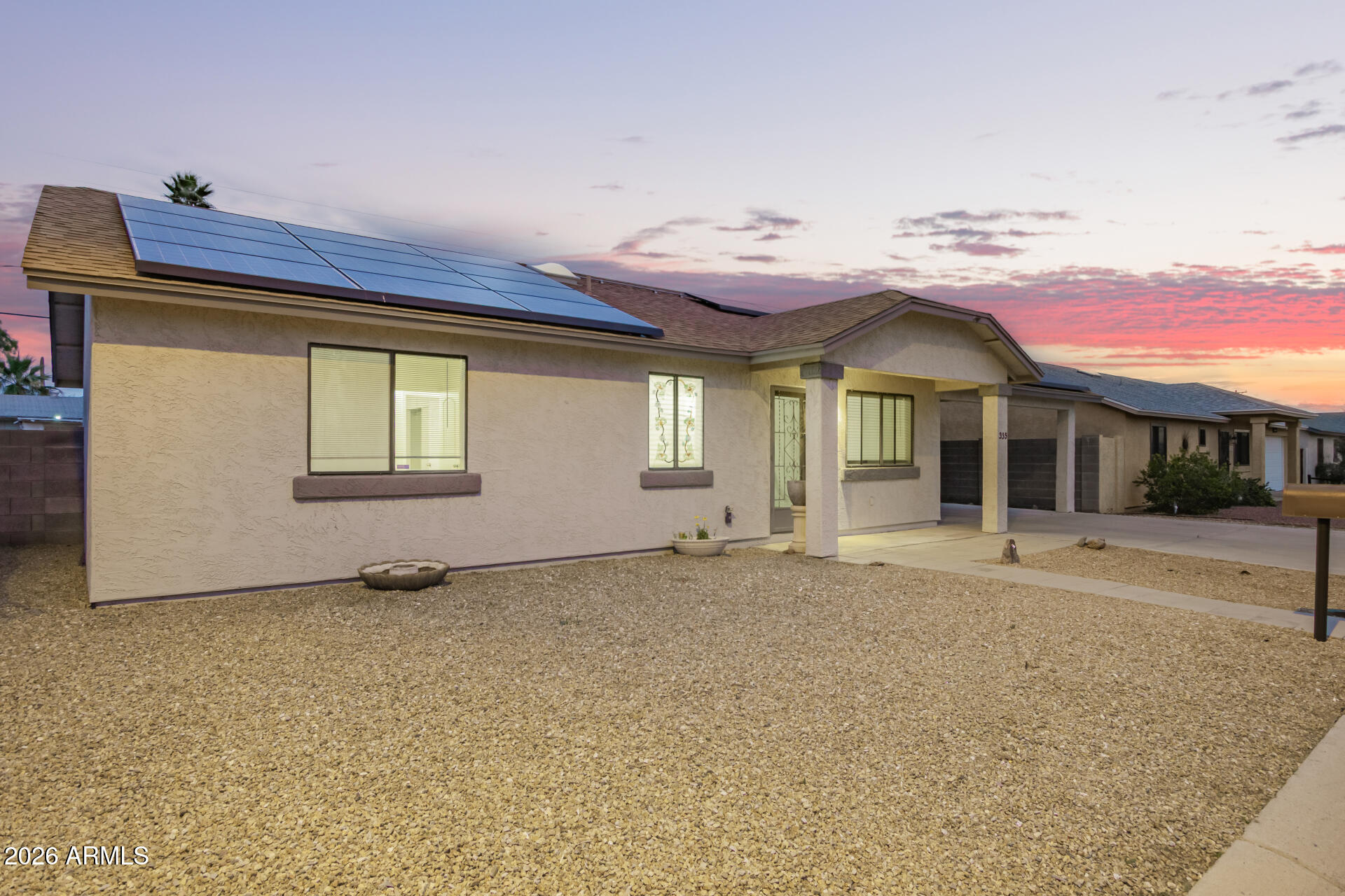 335 South Stardust Lane Apache Junction, AZ 85120 - Photo 28 of 31 a view of a house with a small yard and potted plants