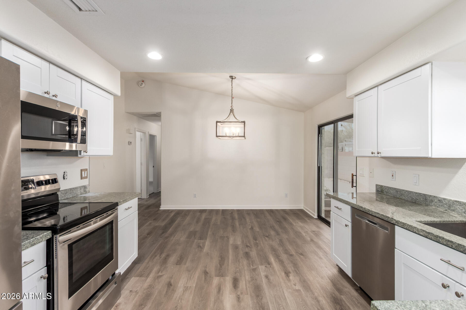 335 South Stardust Lane Apache Junction, AZ 85120 - Photo 7 of 31 a kitchen with stainless steel appliances granite countertop a stove a refrigerator and a microwave