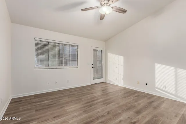 an empty room with chandelier fan