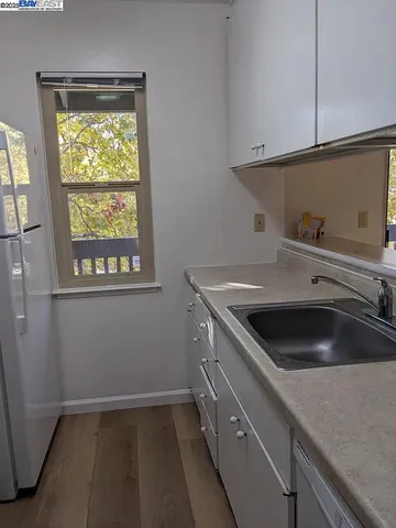 a kitchen with a sink and a window