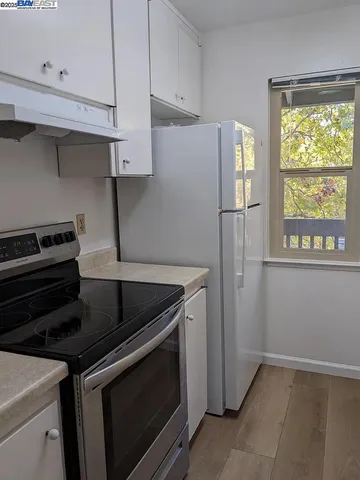 a kitchen with a stove and a refrigerator