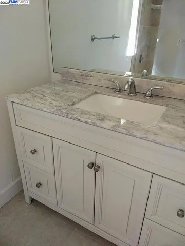 a bathroom with a sink and vanity