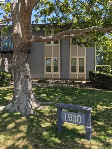 a wooden bench sitting in front of a house