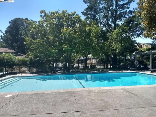 a view of a tennis ground with trees