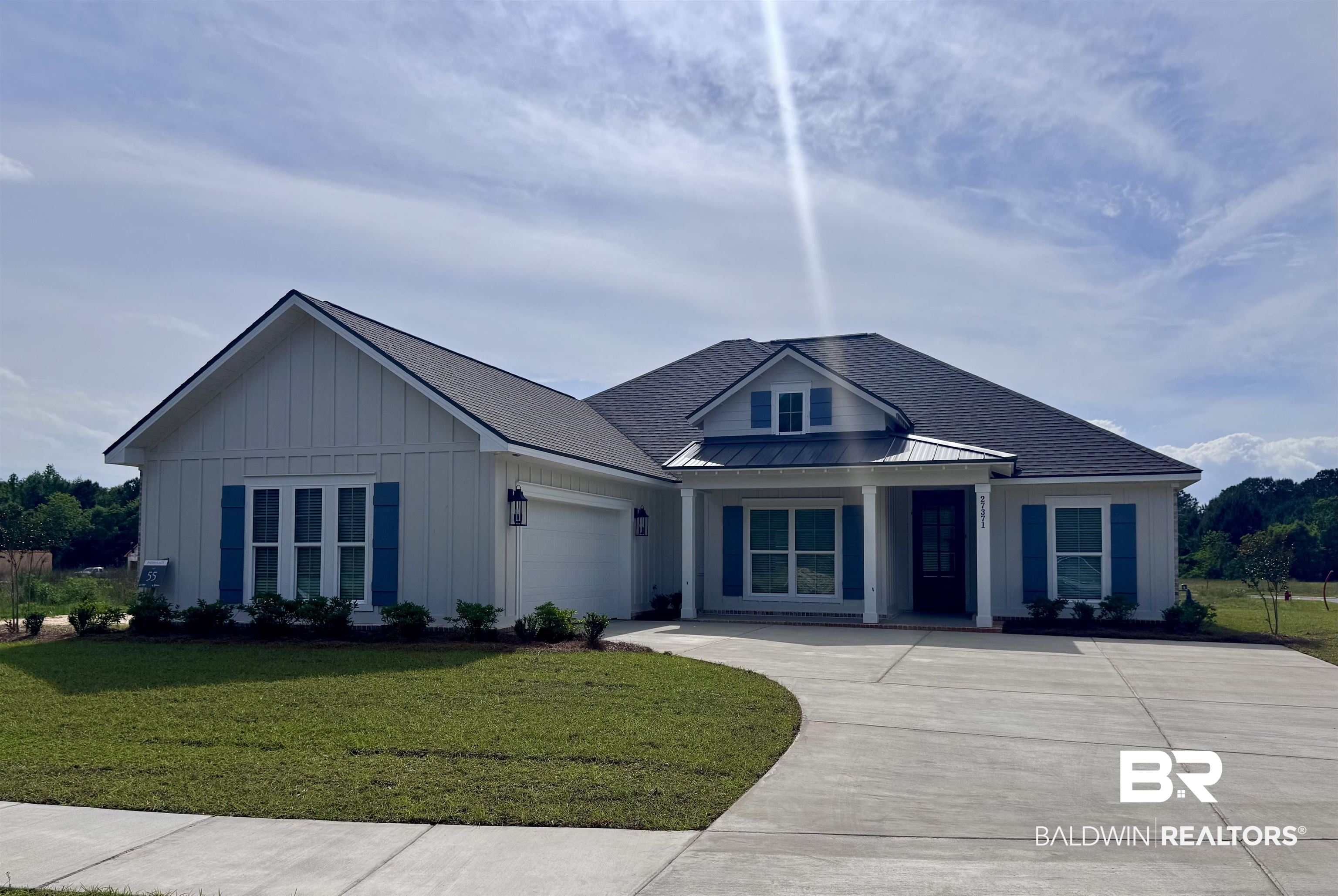 27371 Patch Pl Loop Daphne, AL 36526 - Photo 2 of 63 View of front facade featuring a garage, a front yard, board and batten siding, a standing seam roof, and driveway