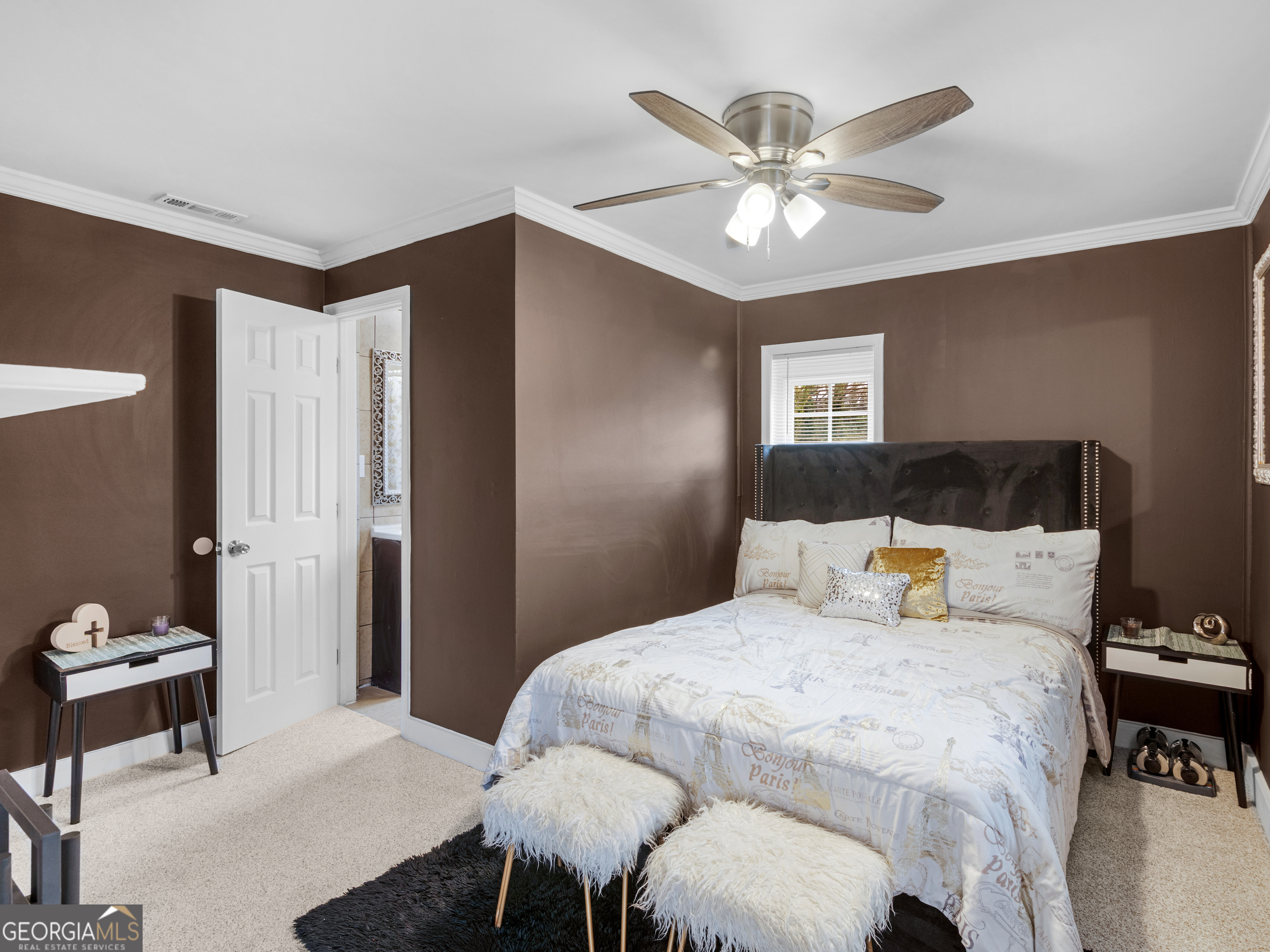 149 Akins Street Barnesville, GA 30204 - Photo 16 of 27 a bedroom with a bed and a chandelier