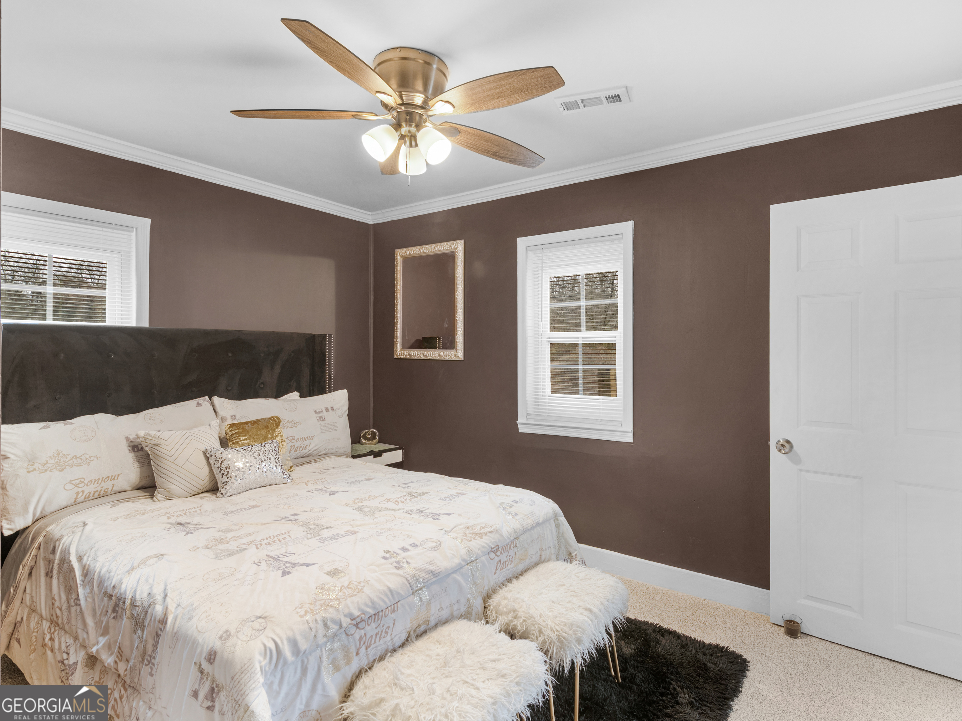 149 Akins Street Barnesville, GA 30204 - Photo 18 of 27 a bedroom with a large bed and a ceiling fan